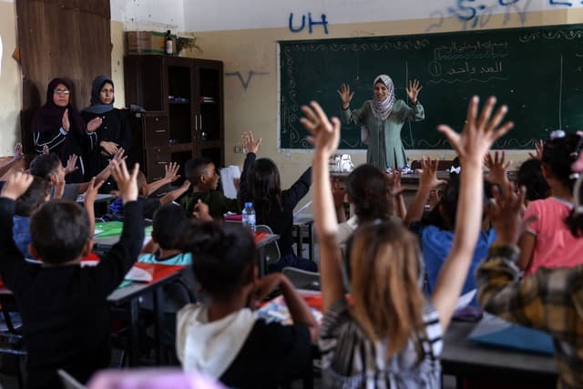 Amina studying in a teacher's home in Gaza